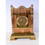 A large 19th Century French brass mantle clock with inlaid embossed copper panels 42 x 17 cm.