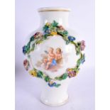 A LARGE MEISSEN FLORAL ENCRUSTED PORCELAIN VASE painted with putti and overlaid with vines. 22 cm x