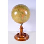 An antique globe mounted on a wooden stand with brass fittings 42 x 22 cm .