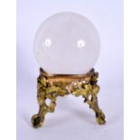 AN ANTIQUE FRENCH ROCK CRYSTAL BALL upon a gilt metal stand. 12 cm x 8 cm.