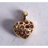 A 14CT GOLD RUBY AND DIAMOND HEART PENDANT. 2.4 grams. 1.5 cm x 1.25 cm.