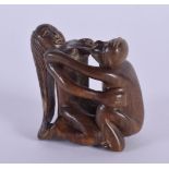 A JAPANESE CARVED BOXWOOD EROTIC NETSUKE. 5 cm x 5.5 cm.