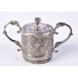 A CONTINENTAL SILVER LIDDED POT DECORATED IN RELIEF WITH CHERUBS IN CLASSICAL SETTINGS. 4.7cm x 7.7