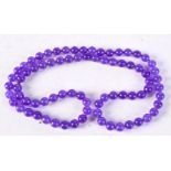 A CHINESE LAVENDER JADE NECKLACE. 70 cm long.