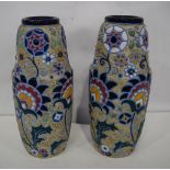 A pair of continental Amphora with glazed floral decoration 24 cm (2).