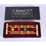 A CHARMING BUSSEYS TABLE CROQUET SET. Box 26 cm x 12 cm.