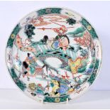 A Chinese porcelain Famille Verte dish decorated with warriors 28 cm.