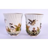 A PAIR OF 19TH CENTURY ITALIAN PORCELAIN BEAKERS decorated in relief with birds in landscapes. 8 cm