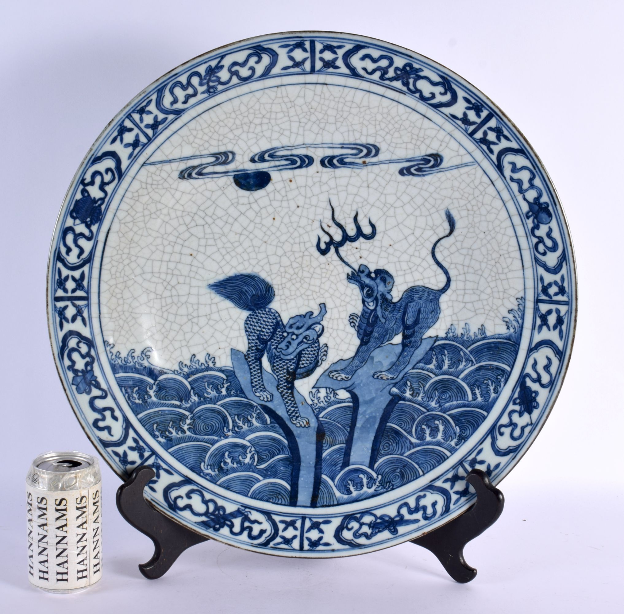 A LARGE 19TH CENTURY CHINESE BLUE AND WHITE CRACKLE GLAZED DISH Qing, painted with buddhistic beasts