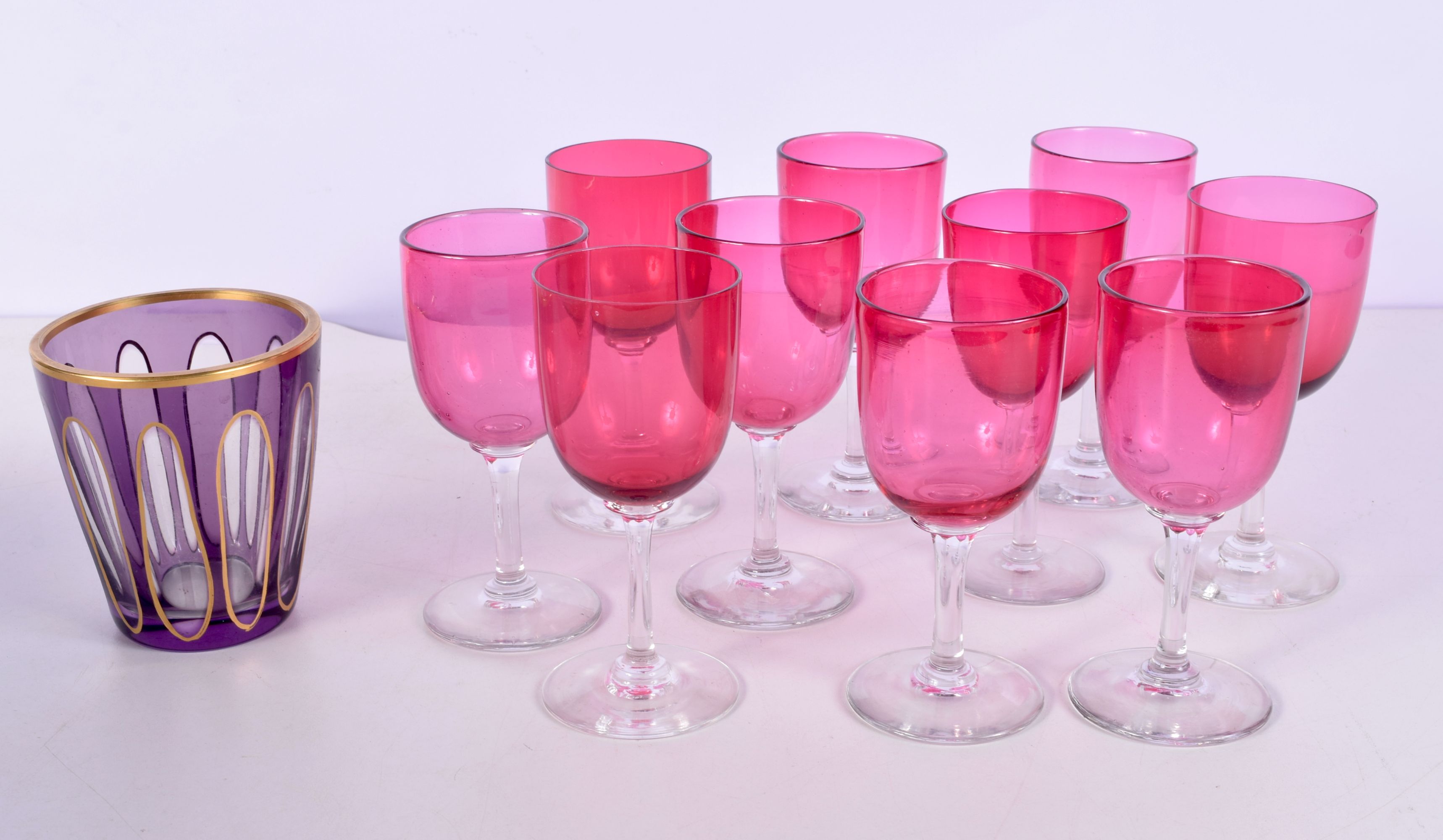A collection of ruby wine glasses, together with an unusual glass tumbler 13cm. (11)