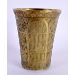 A 19TH CENTURY MIDDLE EASTERN ISLAMIC BRONZE BEAKER decorated with script and animals. 10 cm x 7.5 c