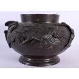 A 19TH CENTURY JAPANESE MEIJI PERIOD BRONZE JARDINIERE decorated with birds in flight. 21 cm x 15 cm