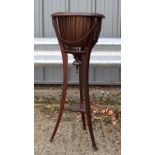 AN EDWARDIAN MAHOGANY POT STAND decorated with lion mask heads. 93 cm x 37 cm.