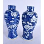 A PAIR OF 19TH CENTURY CHINESE BLUE AND WHITE VASES bearing Kangxi marks to base. 24 cm high.