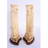 A PAIR OF 19TH CENTURY CONTINENTAL PRISONER OF WAR CARVED BONE VASES of organic form. 23.5 cm high.