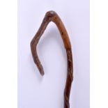 A VINTAGE FOLK ART CARVED WOOD CANE. 78 cm long.