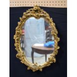 An ornate plaster gilt mirror 60 x 45 cm