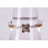 AN 18CT GOLD AND DIAMOND FOUR STONE RING. O. 2.1 grams.