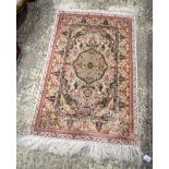 A small Islamic silk rug 122 x 77 cm .