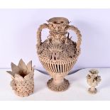 An unglazed pottery urn with finely crafted design of shells plants and birds together with two smal