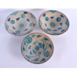 THREE MIDDLE EASTERN ISLAMIC POTTERY FAIENCE BOWLS. Largest 23 cm diameter. (3)