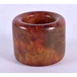 A CHINESE CARVED HORN AGATE ARCHERS RING 20th Century. 2.25 cm wide.