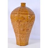 A huge octagonal sided Chinese Meiping vase decorated in relief with dragon and lotus