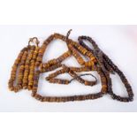 FOUR MIDDLE EASTERN AMBER TYPE PRAYER BEAD NECKLACES. 512 grams. Longest 92 cm. (4)