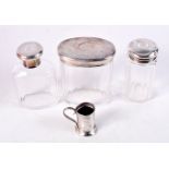 THREE SILVER TOPPED JARS and a silver mug. London 1859 to 1918. Silver 7 grams. Largest 9 cm x 7.5 c