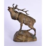 AN EARLY 20TH CENTURY EUROPEAN BRONZE FIGURE OF A STAG modelled upon a rocky outcrop. 15 cm x 10 cm.