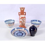 A pair of Chinese porcelain rice grain tea bowls together with a saucer, small satsuma vase and a va