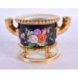 AN EARLY 19TH CENTURY FRENCH EMPIRE PORCELAIN INKWELL painted with flowers. 12 cm wide.