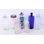 A collection of Apothecary glass jars, bottles together with a glass figure of an Oriental person la