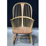 An Ercol blonde chairmakers rocking chair 100 x 75 x 63 cm .