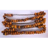 THREE LARGE MIDDLE EASTERN CARVED AMBER TYPE PRAYER NECKLACES. 850 grams. Largest 60 cm long. (3)