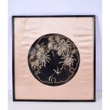 A framed Chinese silk embroidery depicting a bird in foliage 25 cm Diameter .