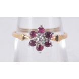 AN 18CT GOLD DIAMOND AND RUBY CLUSTER RING. 2.3 grams. M.