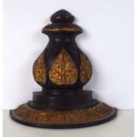 A wooden ebonised wooden wall sconce decorated with coloured glass and a gilt leaf and a metalwork