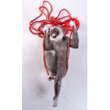 A VINTAGE EUROPEAN BISQUE PAINTED PORCELAIN HANGING MONKEY. 15.5 cm x 7 cm.