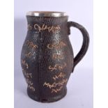 A CHARMING ANTIQUE DOULTON SILVER MOUNTED SLATERS PATENT LEATHER WRAPPED JUG. 22.5 cm high.