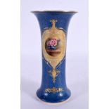Royal Worcester trumpet shaped vase painted with a table with a vase of roses by W. Bagnall, signed,