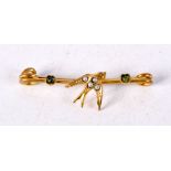 A VICTORIAN BAR BROOCH WITH A SWALLOW AND SET WITH GEMS. 3.3cm x 1cm, weight 1g