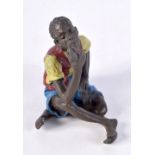 A COLD PAINTED BRONZE FIGURE OF A SEATED TUNISIAN MALE SMOKING A PIPE. 5.6cm x 5.8cm x 4cm