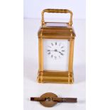 A MINIATURE BRASS CARRIAGE CLOCK. 9 cm high inc handle.