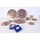 A collection of Royal crown Derby ceramic plates, stands, cups and a boxed napkin set largest 27cm.