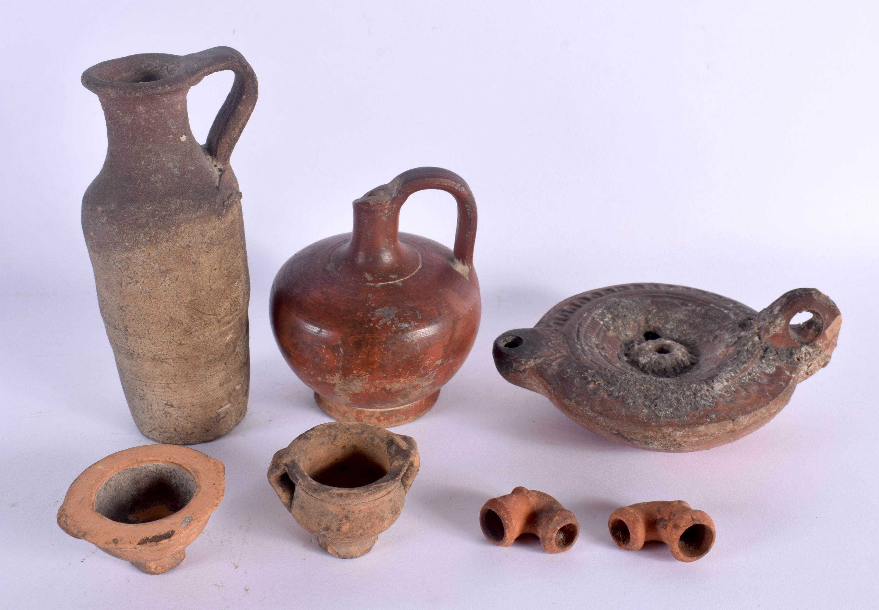 A GROUP OF ANTIQUITIES in various forms and sizes. Largest 11 cm wide. (7)