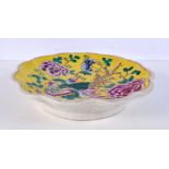 A Chinese porcelain yellow ground dish decorated with a figure 27cm diameter.