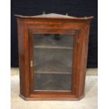 A wooden veneered antique corner glass fronted corner cupboard 87 x 74 cm.