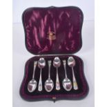 A CASED SET OF ANTIQUE SILVER AND ENAMEL SPOONS. London 1887. 52 grams. 10 cm long. (6)