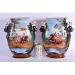 A PAIR OF 19TH CENTURY FRENCH PARIS PORCELAIN VASES painted with figures in landscapes. 34 cm x 19 c